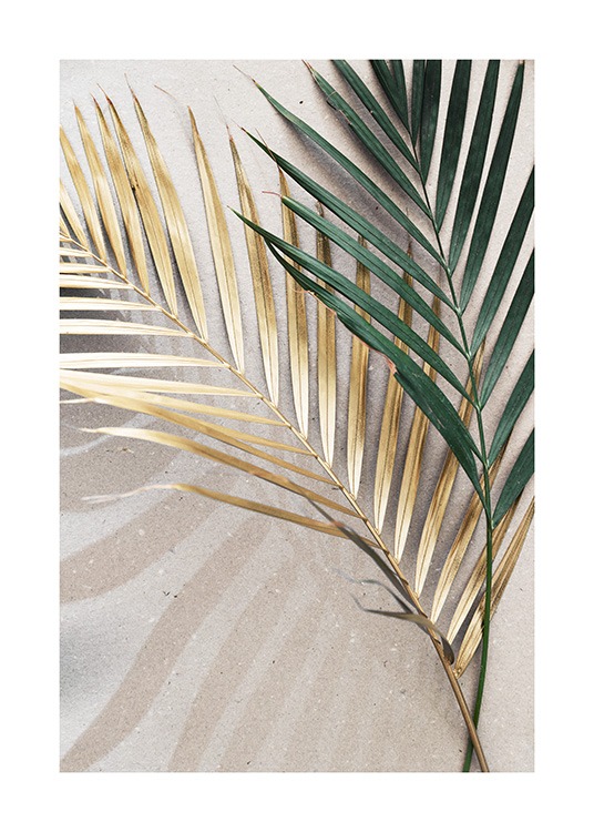  – Photograph of two palm leaves in green and gold, laying on a stone background in beige