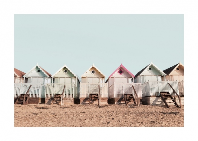 Sandy beach with a brightly coloured row of beach huts