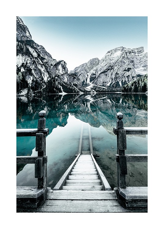  - Nature photograph of snowy mountains behind lake in Braies, Italy, with stairs into the lake
