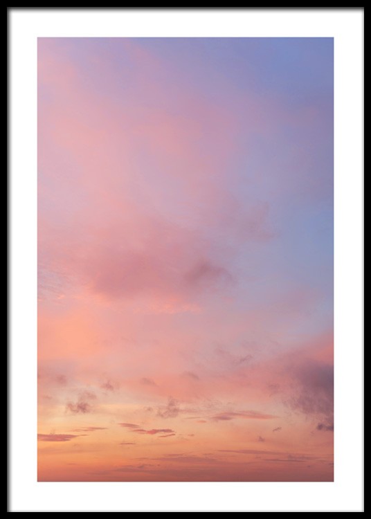  – Photograph of a sunset with pink clouds against a light purple sky