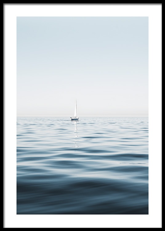  – Photograph of a sailboat in a clear blue ocean with calm waves