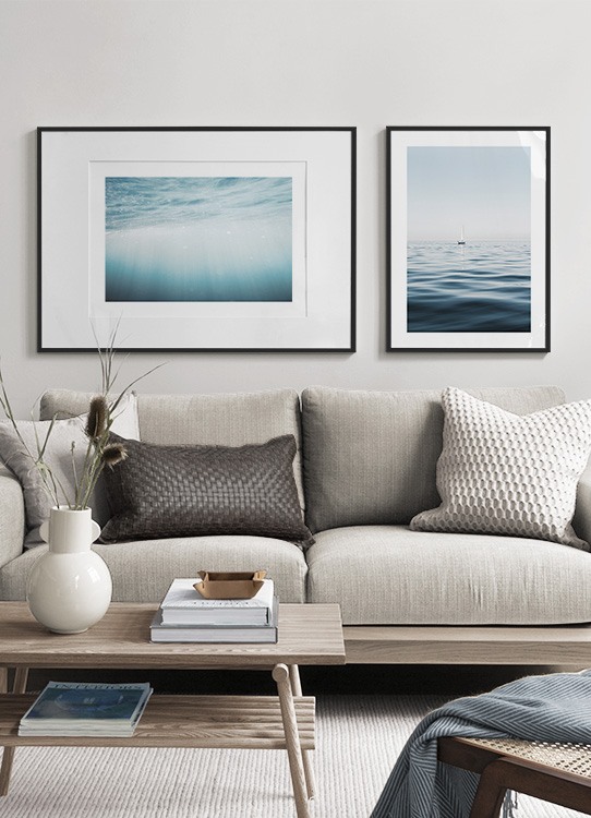 – Photograph of a sailboat in a clear blue ocean with calm waves