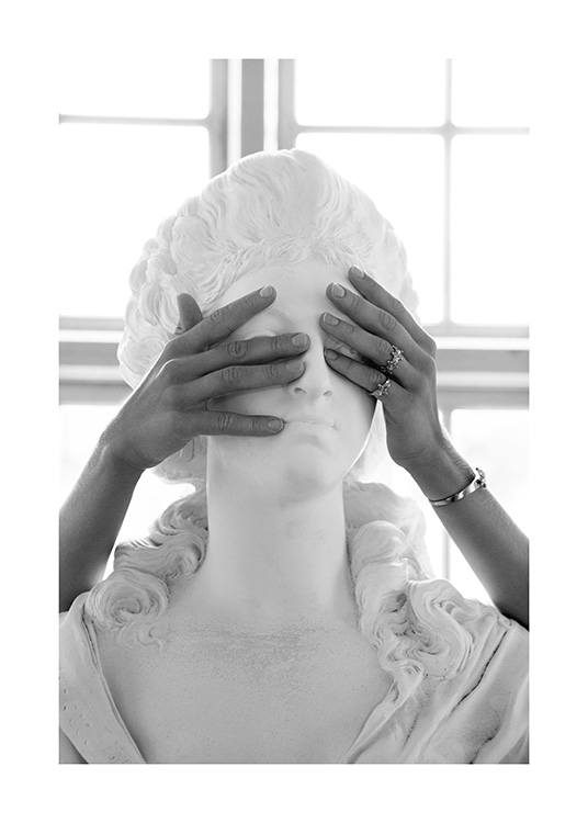  – Black and white photograph of a marble statue, with a woman covering its eyes with her hands