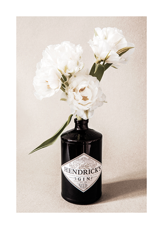  – Photograph of a bunch of white flowers in a black gin bottle against a beige, grainy background