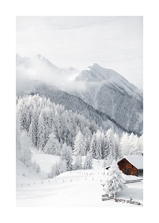 – Photograph of a little cottage in a snow covered landscape with trees and mountains in the background